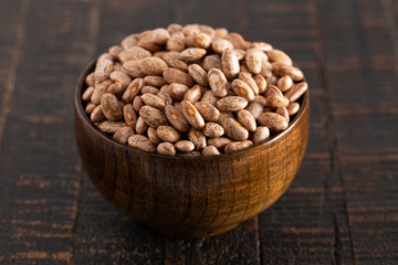 Bowl of Pinto Beans on a Rustic Wooden Table