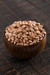 Bowl of Pinto Beans on a Rustic Wooden Table