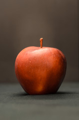 Beautiful red apple against a dark background, isolate