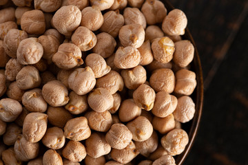 Bowl of Dry Chickpeas on a Rustic Wooden Table