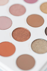 Neutral eyeshadow makeup palette on marble background