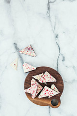 Peppermint white chocolate bark on marble background
