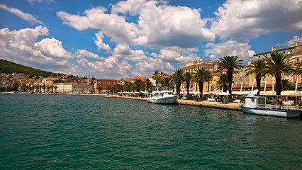 Naklejka na ściany i meble Seafront view at old city center in Split town. Romanesque buildings along sunny pier with palm trees.