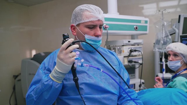 Endoscopy operation at hospital. Doctor holding endoscope before gastroscopy