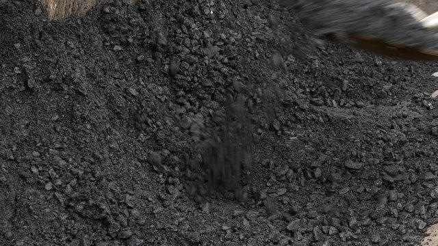 Close up of taking hot bitum asphalt with shovel