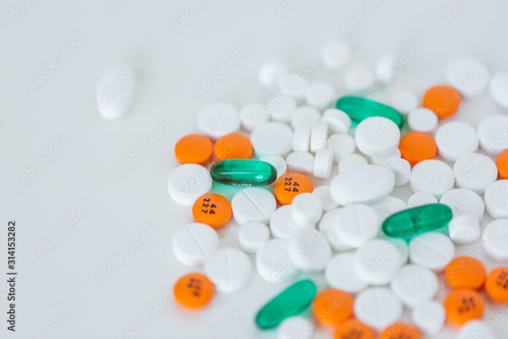 Wall mural Group of assorted prescription pills on white background