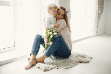 Children give mother flowers. Family at home. Mothers day