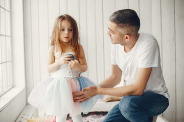 Family at home. Little girl playing with a father.