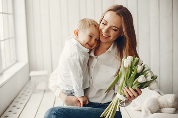 Children give mother flowers. Family at home. Mothers day