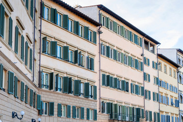 Street with old traditional Italian houses with wooden windows in Florence, Italy