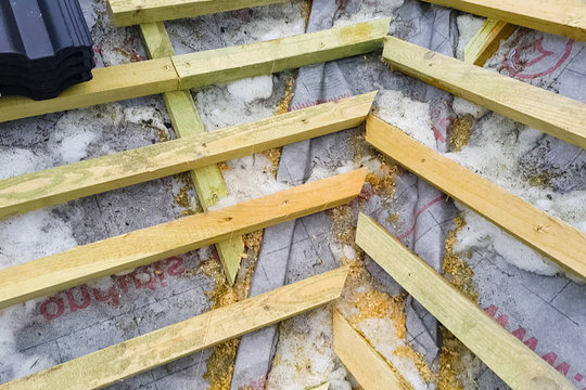 Installation of the roof of the house from ceramic black tiles.