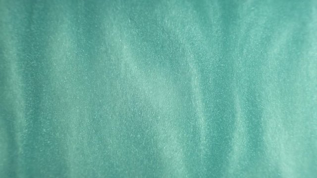 Rheoscopic fluid. Beautiful movement of particles in a liquid. Fantastic patterns and shapes.