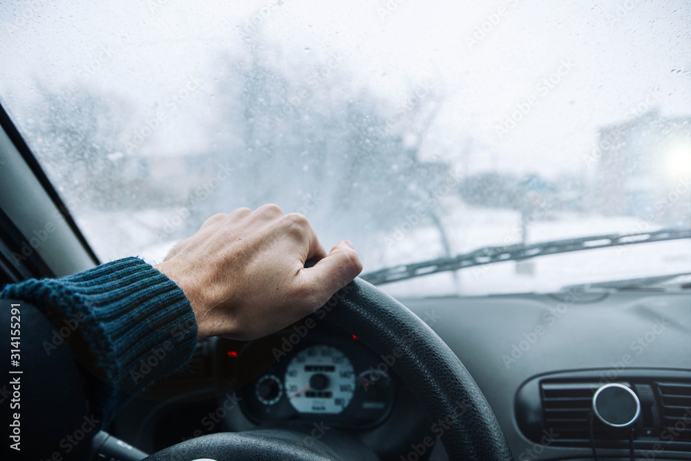 Wall mural Icy road winter road. Winter conditions on the road. View of the driver.