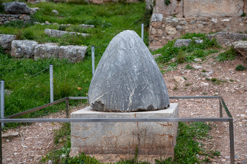 The omphalos stone, navel of the World, archaeological site of Delphi along the slope of Mount...