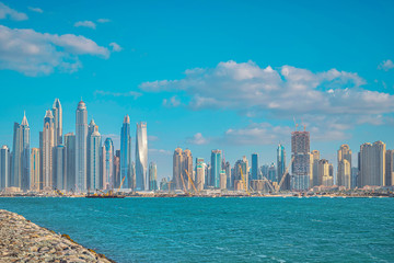 Fototapeta na wymiar View over the Dubai marina district during a bright sunny day in vivid colors from the Palm Jumeirah