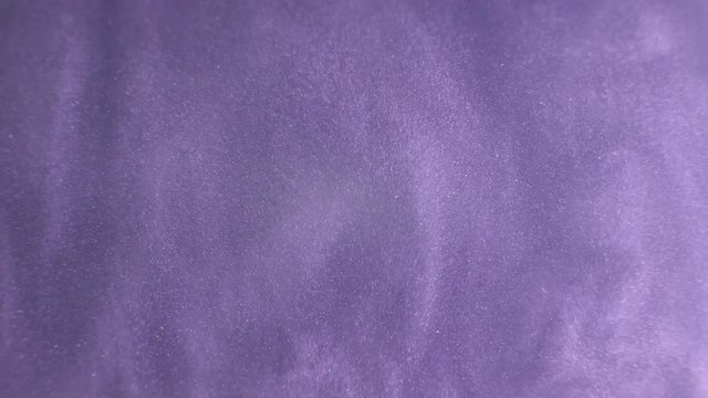 Rheoscopic fluid. Beautiful movement of particles in a liquid. Fantastic patterns and shapes.