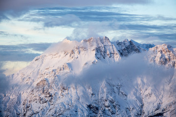 Mountain portrait Birnhorn Saalbach sunset purple light clouds snowy mountain