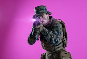 soldier in action aiming laseer sight optics pink background