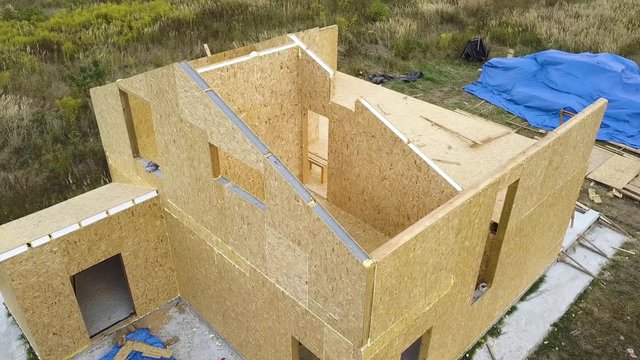 Construction of new and modern modular house. Walls made from composite wooden sip panels with styrofoam insulation inside. Building new frame of energy efficient home concept.