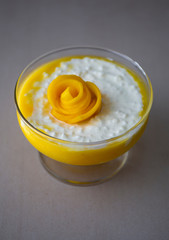 Sweet tapioca pudding with coconut milk and fresh mango flowers