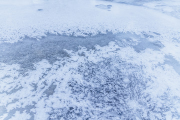 Ice texture, interesting frozen lake patterns, naturally created forms. Frozen river's water in the winter in mount Vitosha, near Sofia, Bulgaria. Ice Age climate changes.