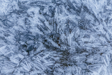 Ice texture, interesting frozen lake patterns, naturally created forms. Frozen river's water in the winter in mount Vitosha, near Sofia, Bulgaria. Ice Age climate changes.