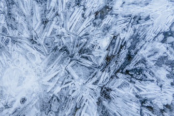 Ice texture, interesting frozen lake patterns, naturally created forms. Frozen river's water in the winter in mount Vitosha, near Sofia, Bulgaria. Ice Age climate changes.