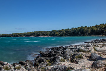 Fototapeta na wymiar Rocky coastline with clear blue water