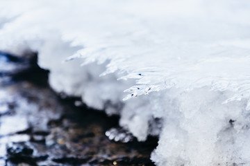 Ice texture, interesting frozen lake patterns, naturally created forms. Frozen river's water in the winter in mount Vitosha, near Sofia, Bulgaria. Ice Age climate changes.