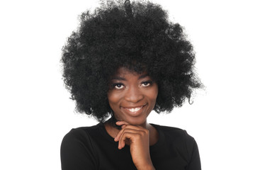 The portrait of young, positive black woman with pretty smle. Young model with afro hair and black...