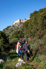 Pylos-Nestor, Messenia, Peloponnese, Greece - January 1 2020: hikers go up on the old castle of Navarino (Palaiokastro or Paliokastro). The site of the Athenian fort  Battle of Pylos.
