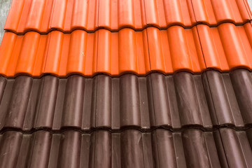 Samples of ceramic roofing tiles in a warehouse of a roofing mat