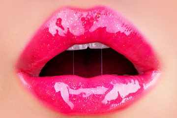 Glossy lips. Lipstick. Sexy mouth and lips close up. Puffy lips. Pink lips with lipstick. Pink...