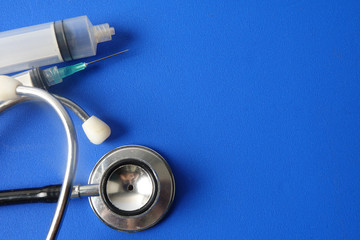 Medical concept with syringe for vaccination isolated on blue background.