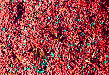 Bright colorful painted red pebbles stones background texture.