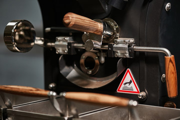 Coffee processing technology. Details of coffee roasting equipment. Close-up.