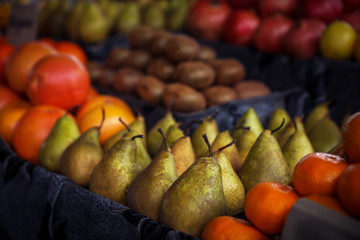 Tasty fresh fruits on counter at wholesale market, closeup