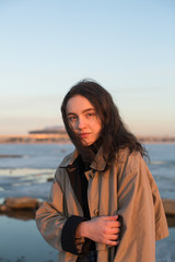 Fototapeta premium Portrait of beautiful young woman. Photoshoot series near river at the winter.