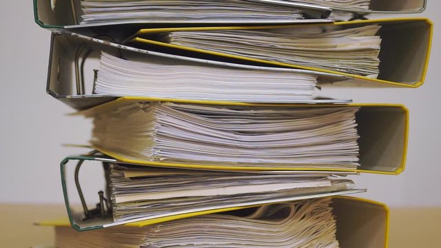 Finance documents in folders. Stacks of files and paperwork in the office: archive, work overload and management concept