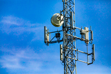 A close up view on the electronic components that make up a cell site tower, multiple antenna and...