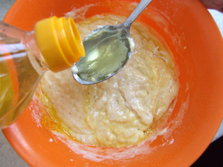 dough in a bowl, adding vegetable oil to the dough, preparing a pancake batter