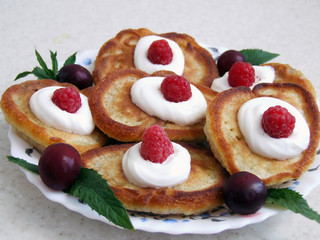 homemade pancakes with berries and cream on a plate, dessert for tea
