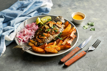 Chita frita al ajo, al ajillo, Peruvian food,  a whole fish, served wit rice, batata, onion salad and rice.