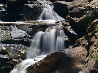 Fototapeta premium Calming river stream in the wilderness with long exposure.