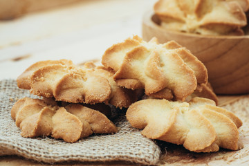 Close-up macro cookies baking on wooden bowl background.