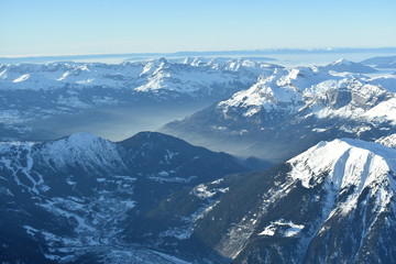 Fototapeta na wymiar Snowy mountains, foggy valley