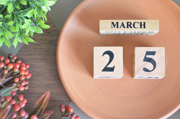 March 25, month design with flower and earthenware.