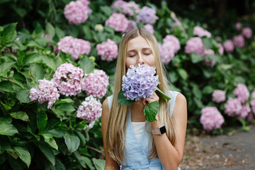 Portrait of beautiful woman with blooming flowers