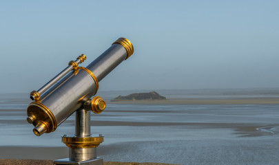 spyglass in first line of sea, of silver and gold chlorine next to a wall