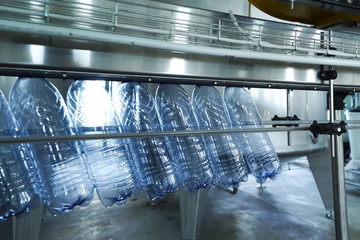 Filling line of sparkling water in pet bottle. Mini factory for